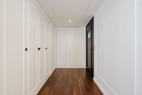 an empty hallway with white closets and a black door at Lisbon Chiado Hotel & Spa in Lisbon