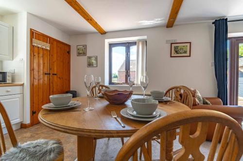 a kitchen and dining room with a table and chairs at Rural Farm Cottage nr Canterbury - logburner, parking, 2bed and 2bath -idyllic setting in Stelling