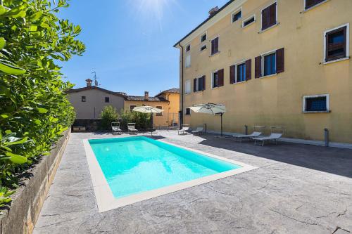 a swimming pool in front of a building at San Carlo Borromeo in Soiano del Lago