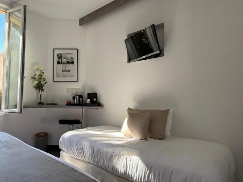 Ένα ή περισσότερα κρεβάτια σε δωμάτιο στο Ideal Sejour Cannes - Hôtel de Charme
