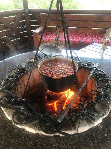 a pot of food is cooking over a fire at ЕкоСадиба Пан Атаман in Skhidnitsa