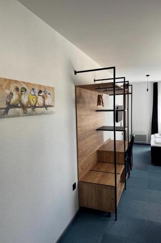 a staircase in a room with a painting of birds at Arena Bakarni in Brčko
