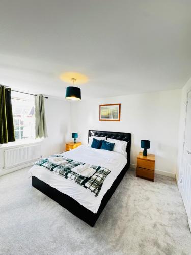 a bedroom with a large bed and a window at Cozy Stays Taunton in Norton Fitzwarren