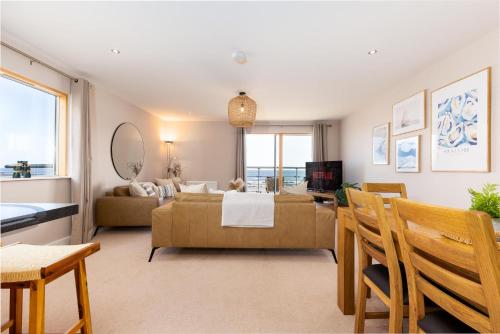 a living room with a couch and a table at The Sands Sea Front Apartments in Scarborough
