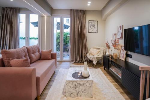 a living room with a couch and a television at Love room & Spa in Larisa