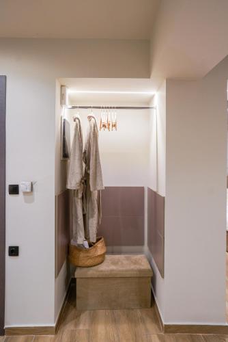 a walk in shower with a bench in a room at Love room & Spa in Larisa