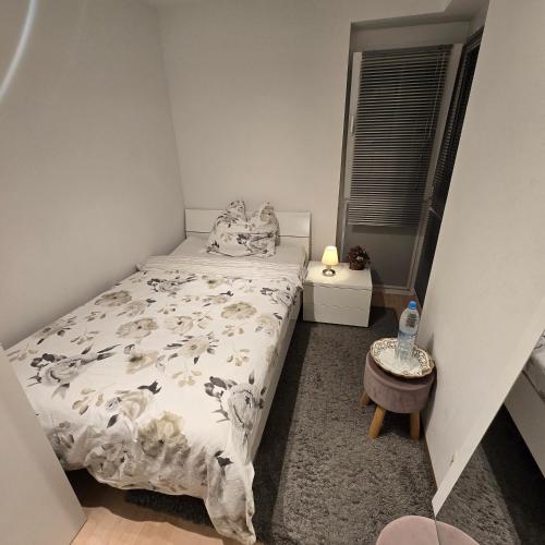 a small bedroom with a bed with sheep blanket at EBE-Connect in Ebersberg