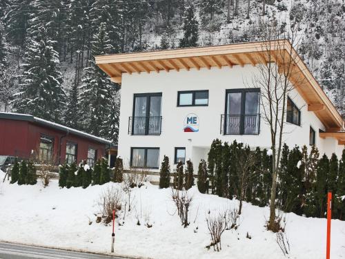 a house in the snow with trees at Holiday Home Zell am Ziller Ski Lift in Zell am Ziller