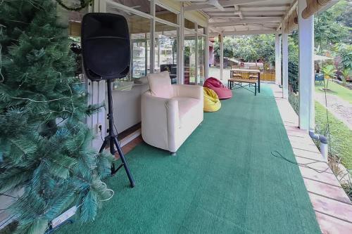 a living room with a christmas tree and a couch at Urbanview Onengan Resort in Palang-Putih