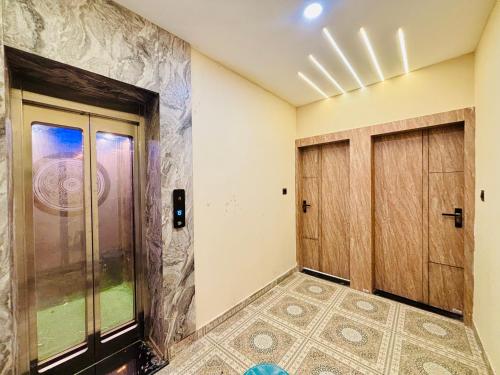 a room with two doors and a tile floor at 3 Raahi Varanasi in Varanasi