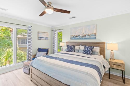 a bedroom with a bed and a ceiling fan at Fairway Dunes 12 - Beach & Golf Dream in Isle of Palms