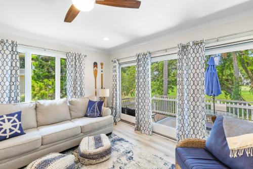 a living room with a couch and windows at Fairway Dunes 12 - Beach & Golf Dream in Isle of Palms