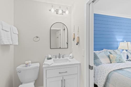 a white bathroom with a sink and a bed at Fairway Dunes 12 - Beach & Golf Dream in Isle of Palms