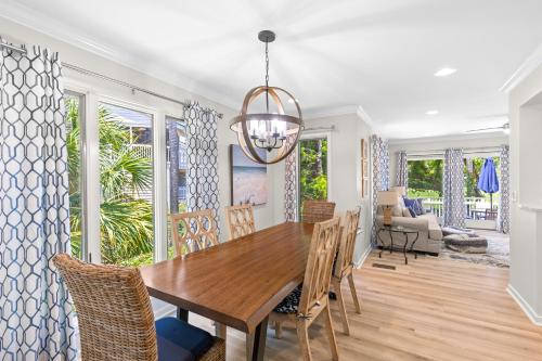 a dining room with a wooden table and chairs at Fairway Dunes 12 - Beach & Golf Dream in Isle of Palms