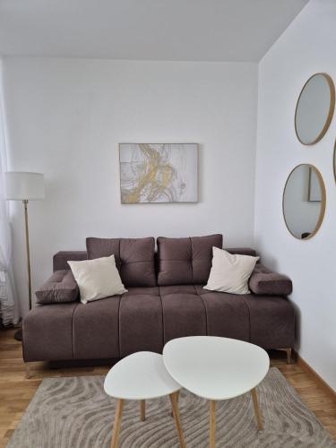 a living room with a couch and a table at Sokolis Apartman in Kragujevac