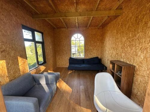 a living room with a couch and a window at The Bus Stop, Thornham Magna in Thornham Magna