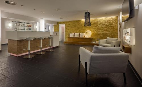 a lobby with chairs and a bar in a building at DoubleTree by Hilton Hannover Schweizerhof in Hannover