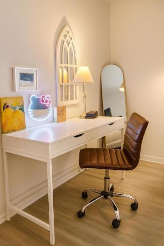 a white desk with a chair and a mirror at Wabi Sabi SoCo Retreat- Relax, Work and Soak in the Pool in Austin