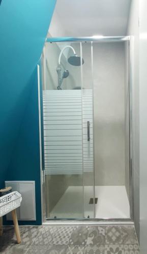 a glass shower stall with a sink in a bathroom at Magnika in Sapareva Banya