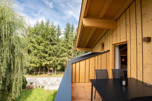 a house with a black table on a patio at Haus Eder in Saalfelden am Steinernen Meer
