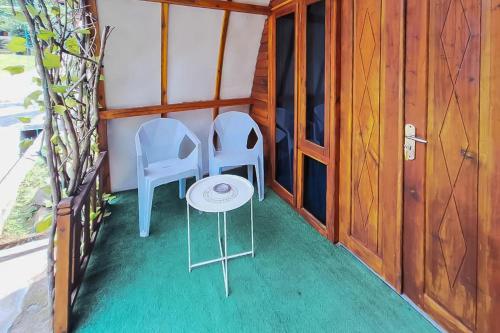 two chairs and a table in a small room at Urbanview Onengan Resort in Palang-Putih