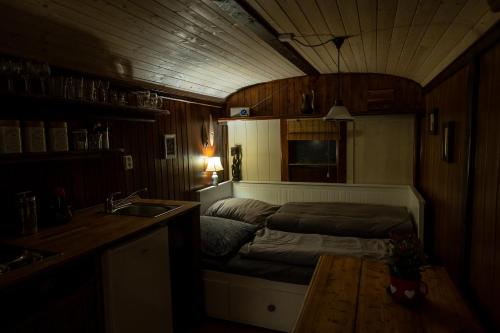 a small bedroom with a bed and a sink at Tiny-House in Paradise - Maringotka v Raji in Turnov