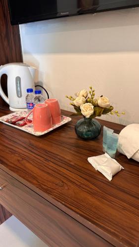a table with a plate of food and flowers on it at Paradise Langkawi in Pulau Tepur