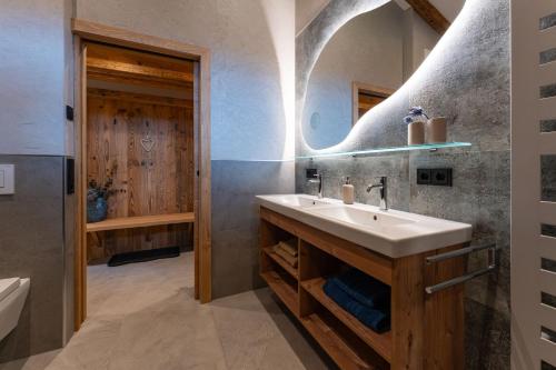 a bathroom with a sink and a mirror at Haus Eder in Saalfelden am Steinernen Meer