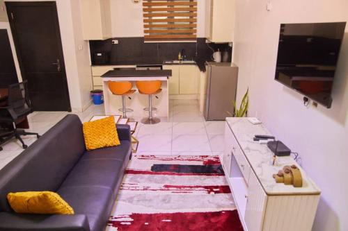 a living room with a couch and a table at The Residence 6 in Lekki
