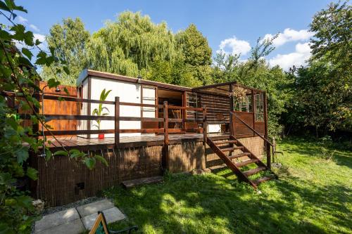 a tiny house in a yard with a fence at Tiny-House in Paradise - Maringotka v Raji in Turnov
