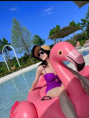 a woman in a purple swimsuit sitting on a pink inflatable at 花蓮壽豐 - Twinkle Night 星空說民宿A館 in Zhixue