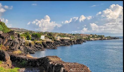 a view of a river with rocks and houses at Punta Aguzza in Aci Castello