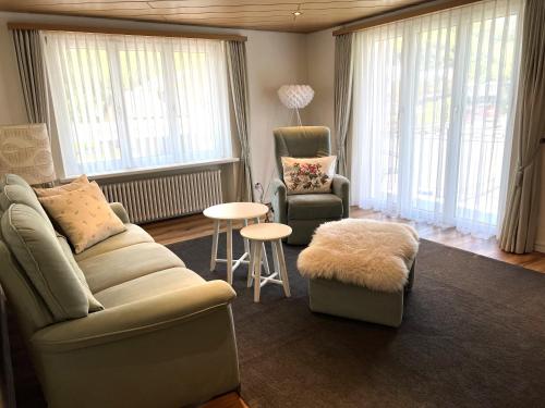 a living room with a couch and a chair and a table at Ferienwohnung Michels in Realp