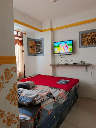 Ένα ή περισσότερα κρεβάτια σε δωμάτιο στο D Rooms Apartemen