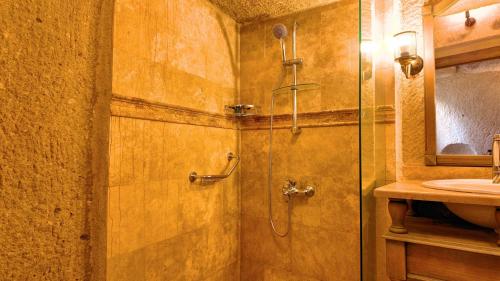 a bathroom with a shower with a glass door at Anjelic Cave Cappadocia in Urgup