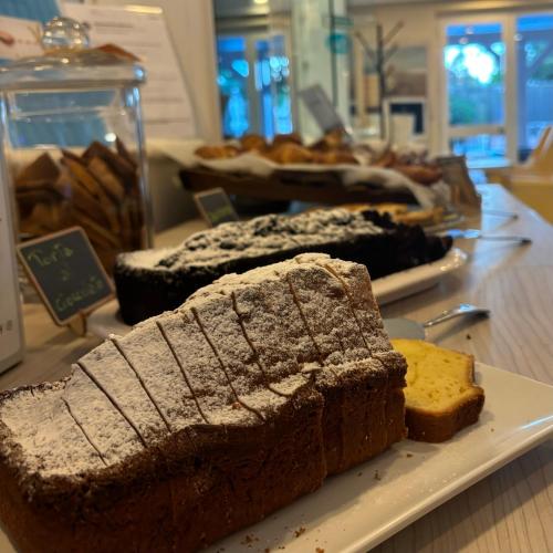 a plate with bread and other pastries on a table at Hotel Eden in Cinquale