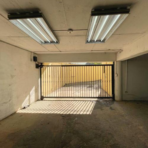 an empty room with a gate in a building with lights at Hostal PdeV in Concepción