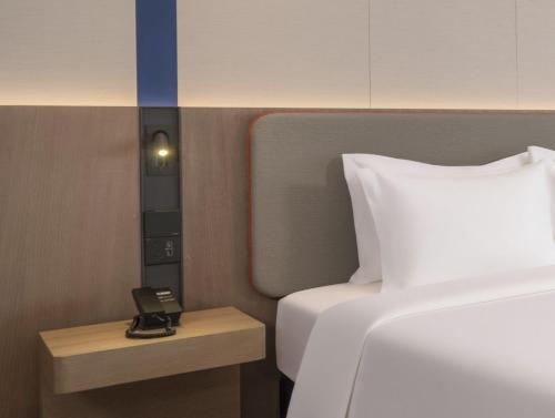 Ένα ή περισσότερα κρεβάτια σε δωμάτιο στο Holiday Inn Express Aksu by IHG