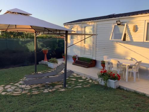 a patio with an umbrella and a table and chairs at Casa vacanze Soleil in Alghero