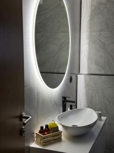 a bathroom with a white sink and a mirror at Villa Alba in Kupres