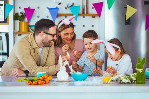 a family sitting at a table eating cake at Candlewood Suites Augsburg in Augsburg