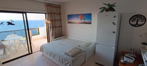 a bedroom with a bed and a view of the ocean at Ladybug Ocean View in Costa Del Silencio