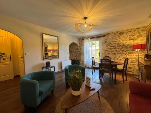 a living room with a couch and a table at Domaine de Brise Bois - Chambres & Gîtes in Rouzède