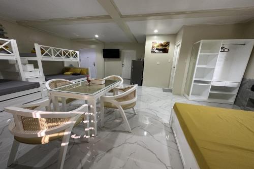 a living room with a table and chairs and bunk beds at Michael's Homestay - Farm Villa near Patar Beach & Bolinao Falls in Bolinao