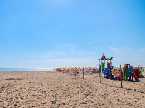 a beach with a row of playground equipment at Sunny holiday flat-Beahost in Rosapineta