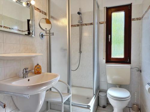 Un baño con lavabo, inodoro y ducha. en Baltique - Ferienwohnung 2 Glowe, en Glowe