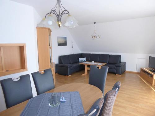 a living room with a table and a couch at Baltique - Ferienwohnung 7 Glowe in Glowe