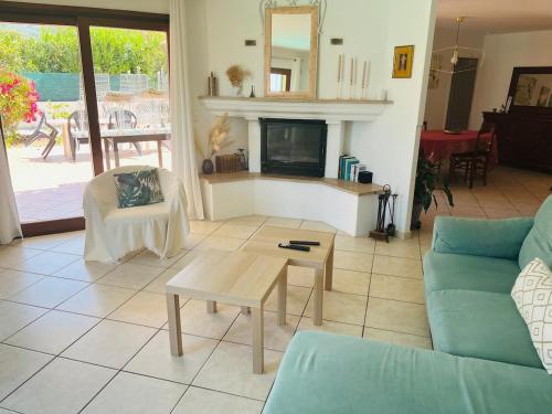 a living room with a couch and a fireplace at Villa 3 chambres avec piscine et parking privés in Calenzana
