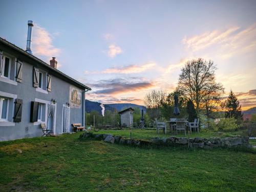 ein Haus mit einem Tisch und Stühlen im Hof in der Unterkunft Notre Renardière, Gîtes à Saulxures-sur-Moselotte, Hautes-Vosges in Saulxures-sur-Moselotte