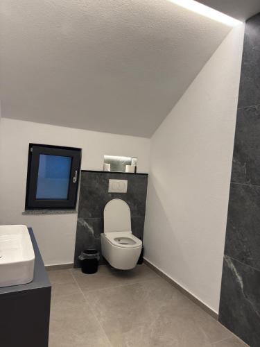 a bathroom with a toilet and a sink at Kulla Emini Valbone 2025 in Valbonë